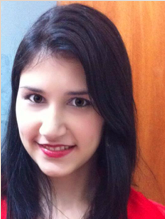 Aluna Lais Gonzaga Machado Snidei, Jovem branca, olhos castanhos escuros, cabelo castanho, liso e abaixo do ombro. Ela usa camiseta de cor vermelha, batom da mesma cor e está sorrindo.
